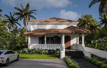 White Goan heritage home with a tiled roof and tropical garden