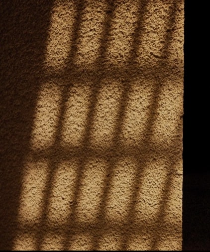 Sculptural stone surface shaped by light and shadow